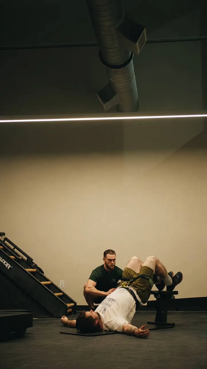 One-on-one coaching during a floor-based strength exercise